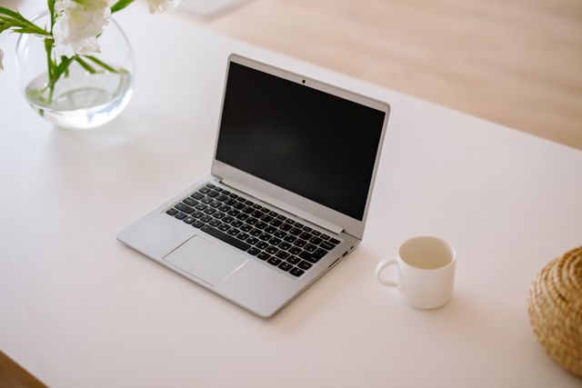 a laptop and mug on a desk